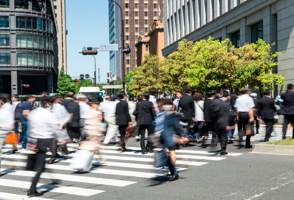 A group of people cross a pedestrian crossing 
