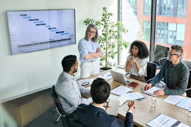 Several people talking in a meeting room.