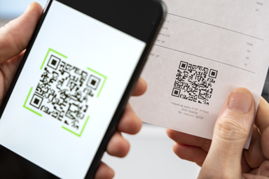 A person scans a QR code on his smartphone.