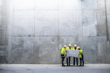 Workers consult a site plan.