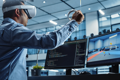 A man in a virtual reality headset plays on his computer