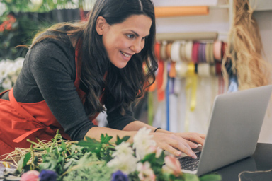 A florist typing on her computer.