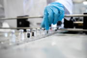 A scientist with vials of vaccines.