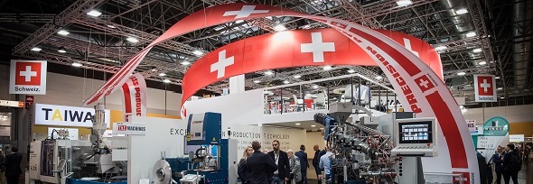 People at exhibition stands with Swiss flags