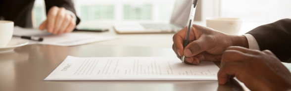 A man fills a document with a pen 