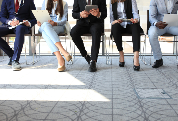 Men and women sit in an office