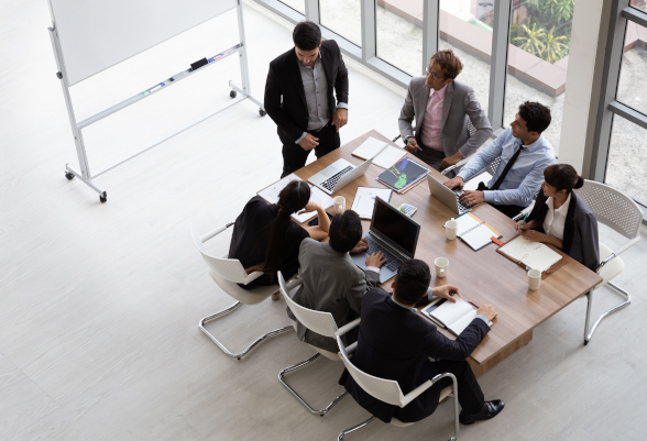 A group of people sit around a table during a (work) meeting