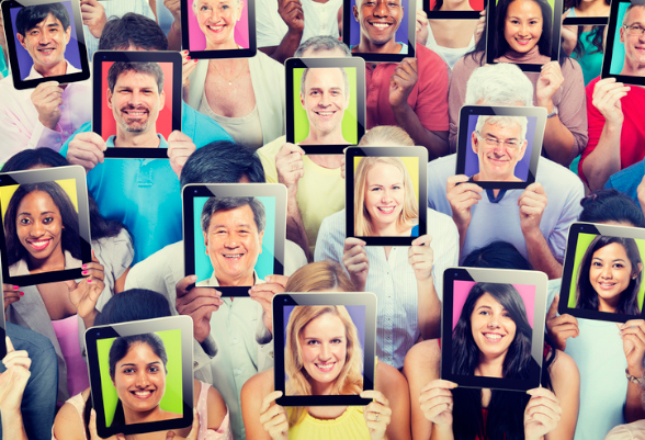 A group of people holding on their forehead touchpads displaying the face of other people