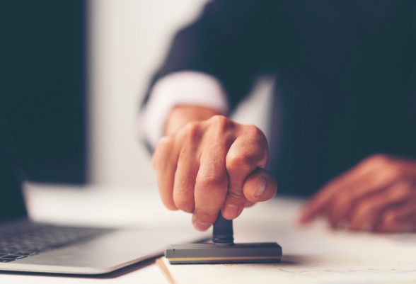 A man stamps a document