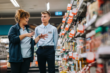 Two employees in a grocery store.