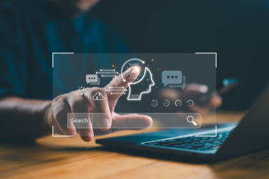 A person’s fingertip touches an icon of a head labeled "AI"