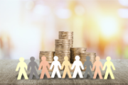 Linked paper figures with coins in the background