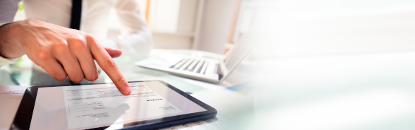 A man studying a document on a touch pad/ tablet