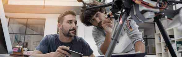 Two men inspecting a technical construction.