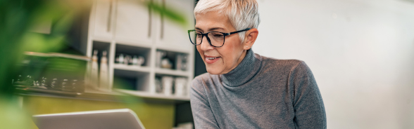 A woman seating in front of her computer.