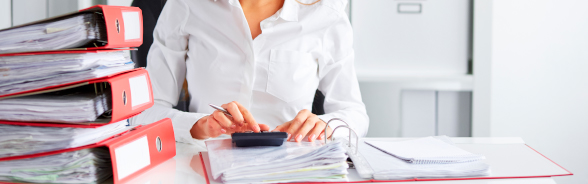 A woman performing calculations using a calculator.