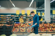 Un uomo acquista delle mele in un supermercato.
